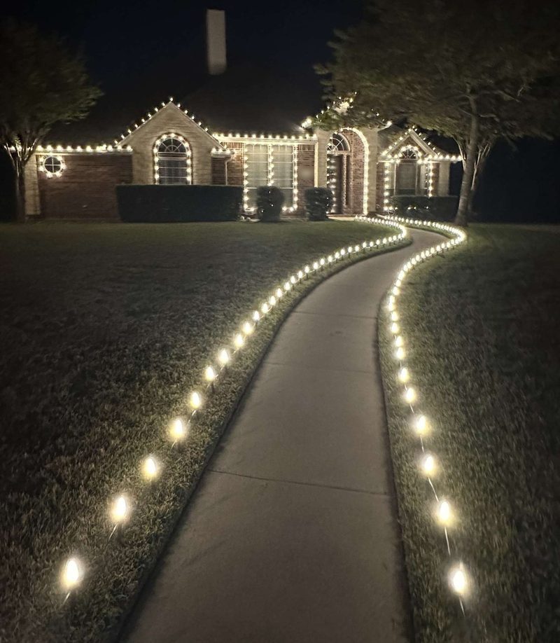 Warm white along the roofline, with the walkway staked out to the street