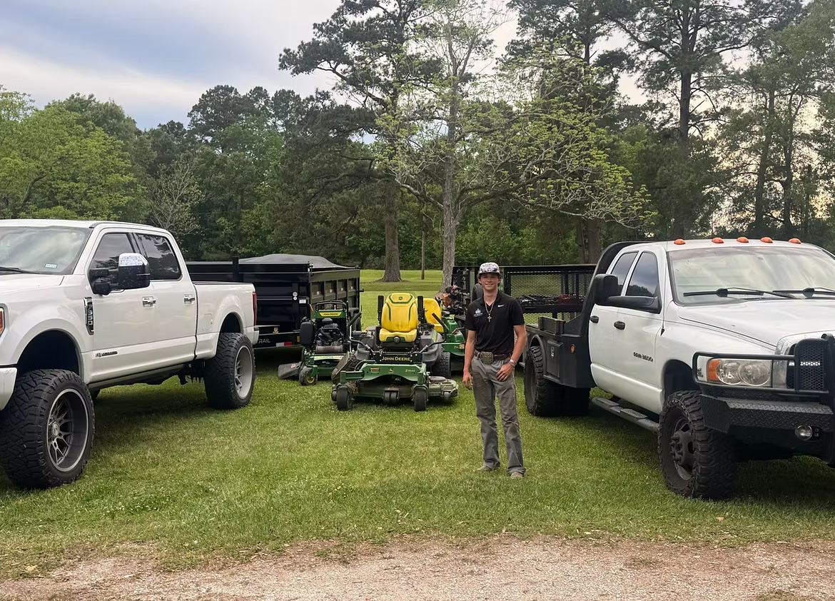 Kaden with the Pinewoods trucks and mowers