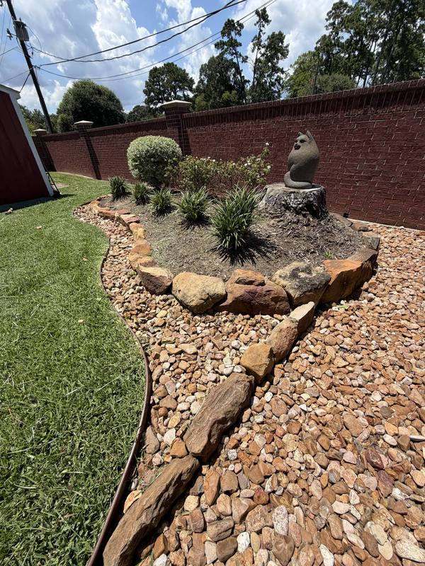 Backyard rock garden with boulders and ornamental grasses