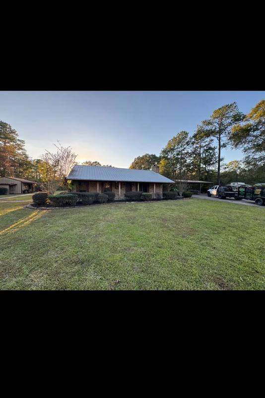 Freshly mowed lawn and trimmed shrubs at a country home we maintain